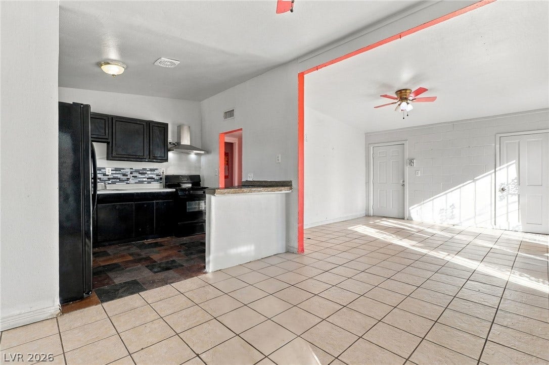 2521 Perliter Avenue, North Las Vegas, NV 89030 Tiled flooring flows through an open-concept layout connecting the kitchen and living space.