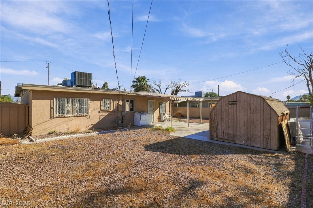 2521 Perliter Avenue, North Las Vegas, NV 89030 A spacious backyard area includes a concrete patio and a free-standing wooden storage shed.