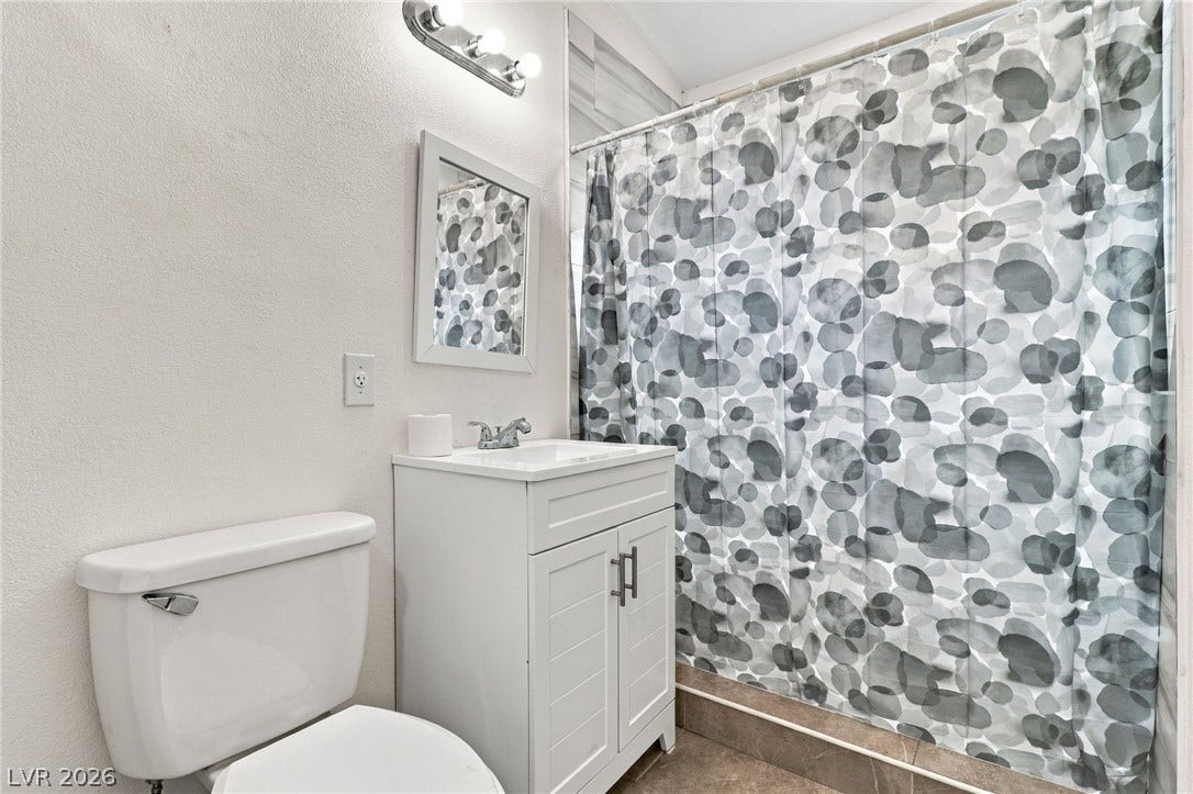 2521 Perliter Avenue, North Las Vegas, NV 89030 An updated vanity and modern fixtures complete this functional bathroom space.