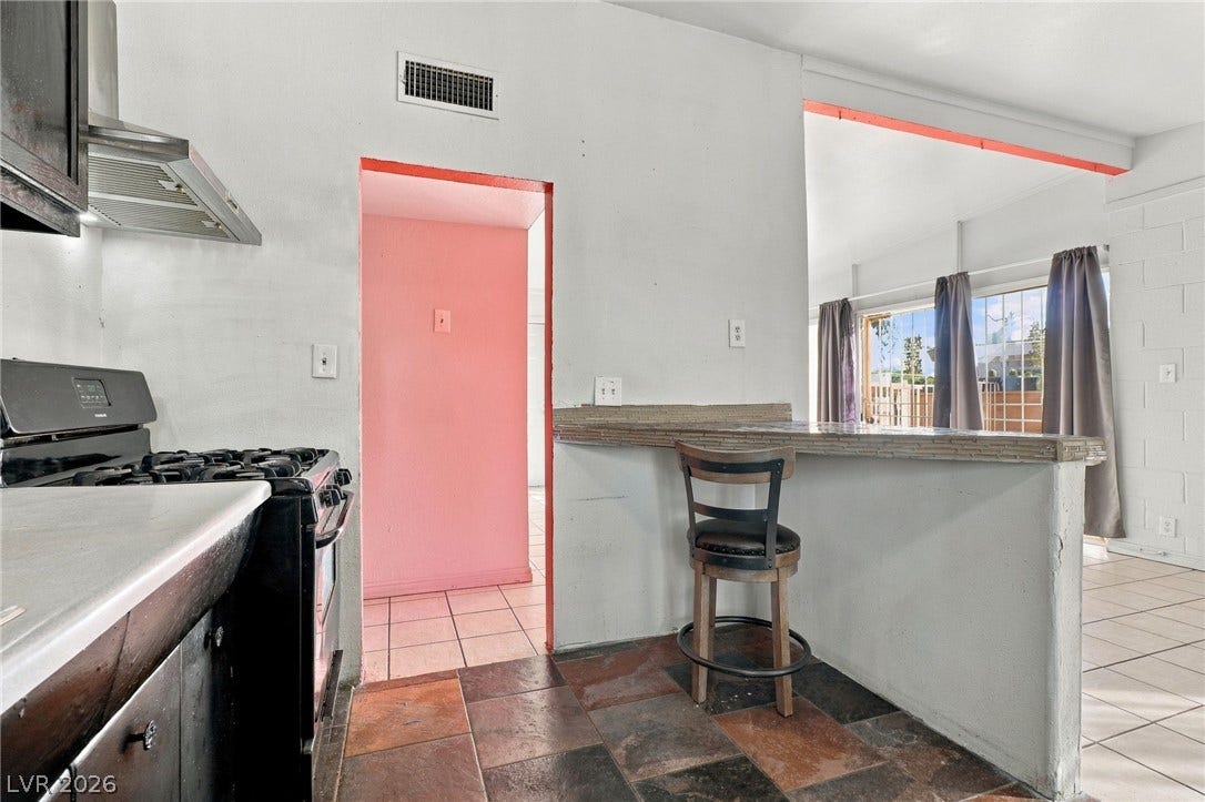 2521 Perliter Avenue, North Las Vegas, NV 89030 An open bar counter connects the kitchen to the adjoining living space.