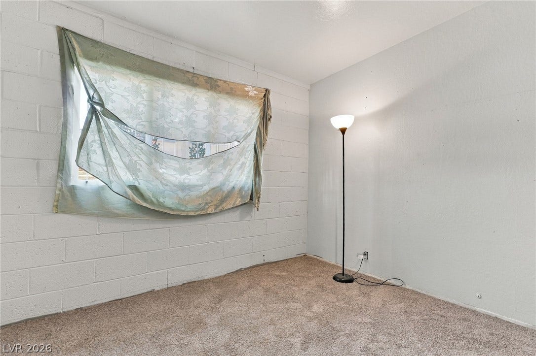 2521 Perliter Avenue, North Las Vegas, NV 89030 Concrete block walls and wall-to-wall carpeting define this versatile interior space.