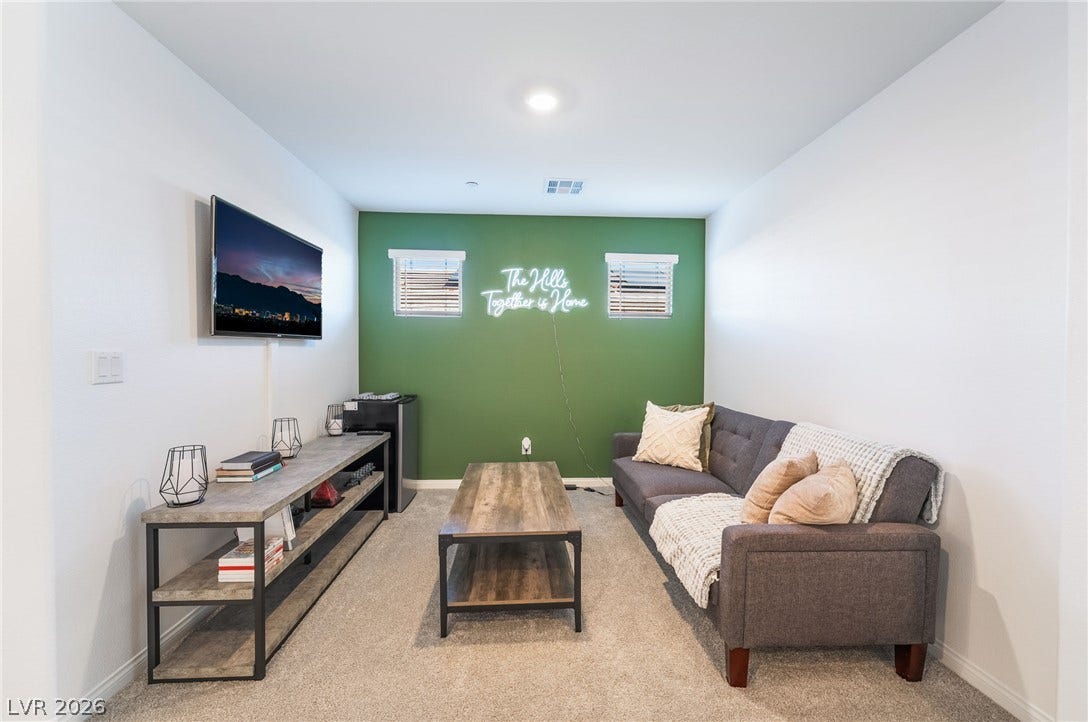 10958 Cheshire Woods Avenue, Las Vegas, NV 89166 Recessed lighting illuminates this versatile living space featuring neutral walls and plush carpet.