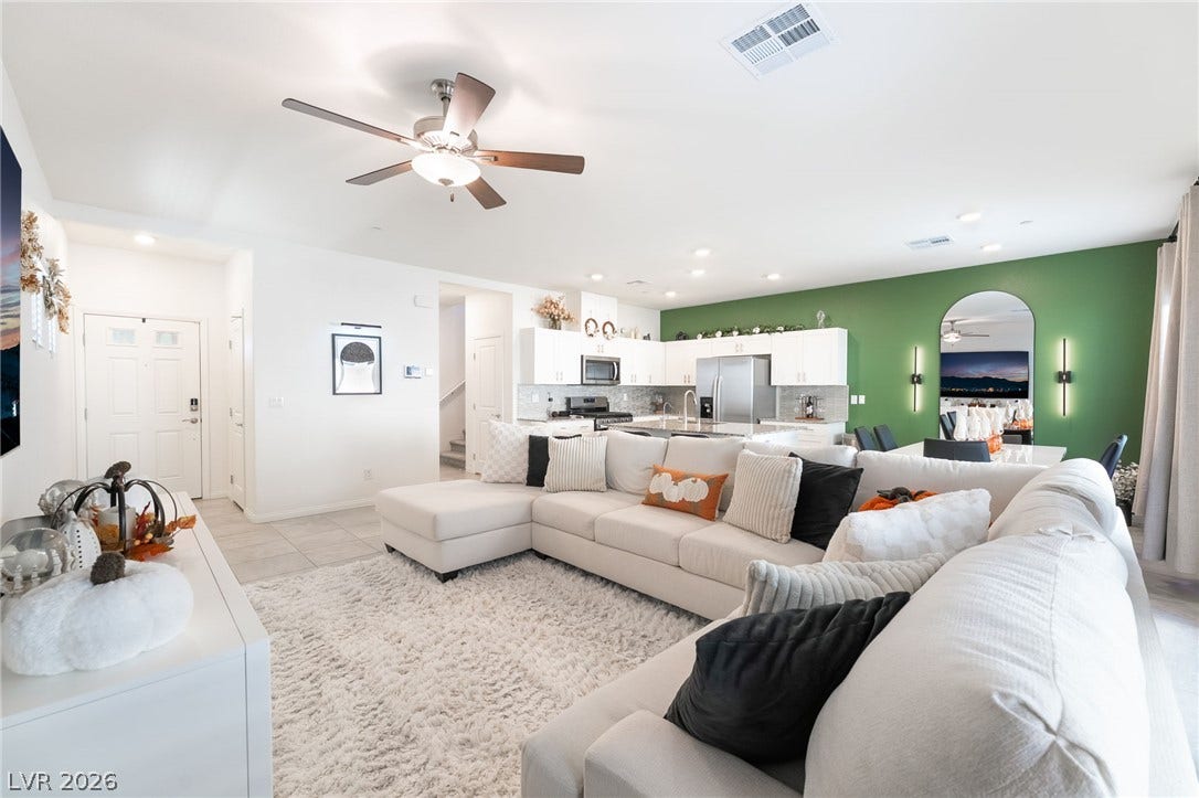 10958 Cheshire Woods Avenue, Las Vegas, NV 89166 An open floorplan seamlessly connects the airy living area with a modern kitchen.