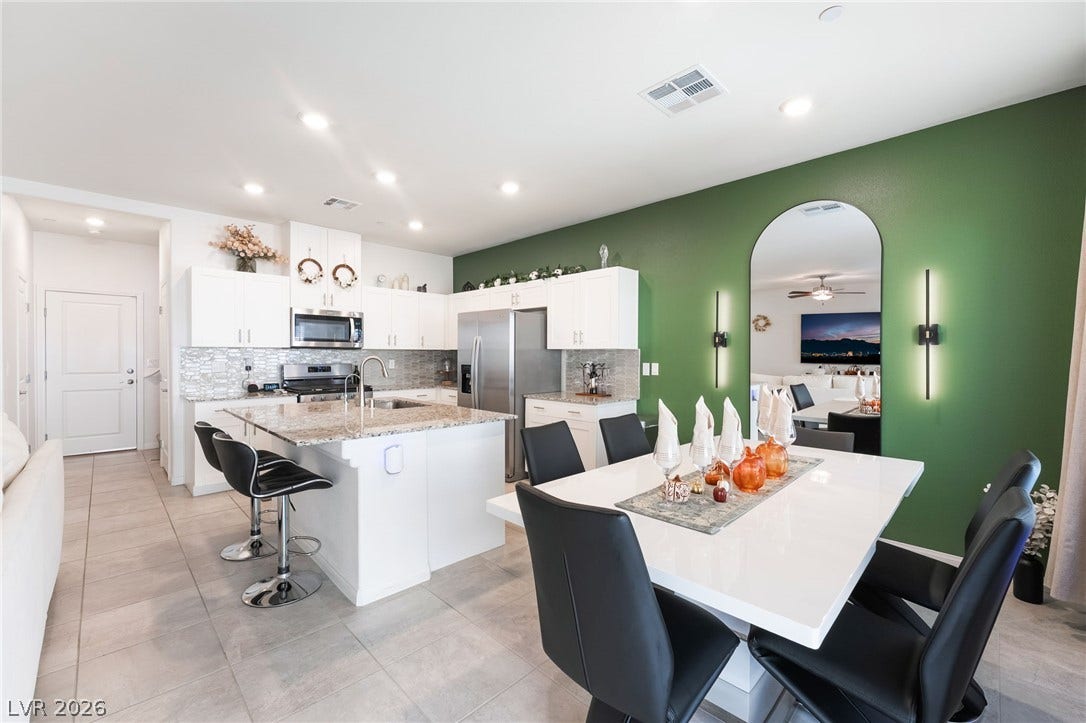 10958 Cheshire Woods Avenue, Las Vegas, NV 89166 Gleaming tile floors flow seamlessly from the dining area into a well-appointed open kitchen.