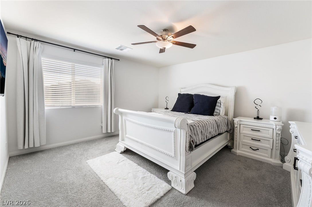 10958 Cheshire Woods Avenue, Las Vegas, NV 89166 Plush wall-to-wall carpeting and a wide window bring warmth to this quiet bedroom space.