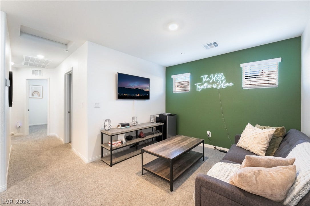 10958 Cheshire Woods Avenue, Las Vegas, NV 89166 Plush carpeting and recessed lighting create a comfortable atmosphere in this versatile common area.