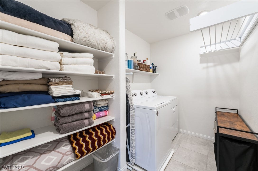 10958 Cheshire Woods Avenue, Las Vegas, NV 89166 Ample shelving and built-in storage maximize efficiency in this tile-floor laundry space.