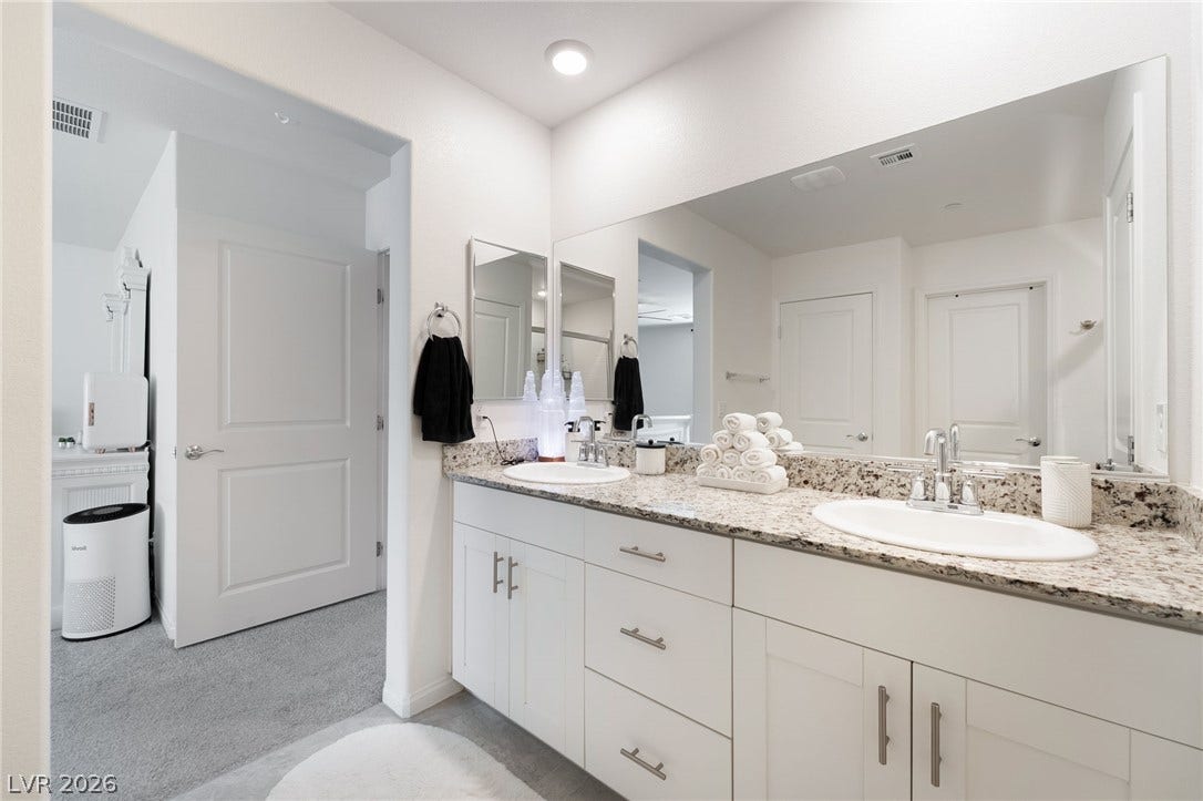 10958 Cheshire Woods Avenue, Las Vegas, NV 89166 Granite countertops and dual basins define this modern master bathroom layout.