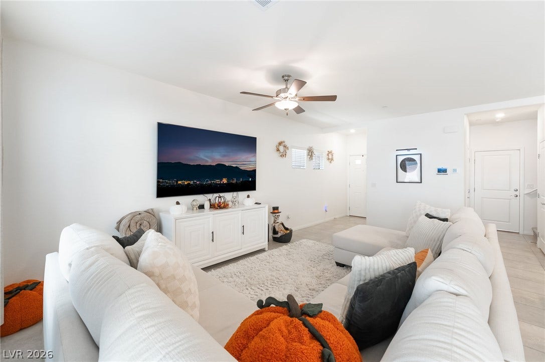 10958 Cheshire Woods Avenue, Las Vegas, NV 89166 Clean lines and smooth flooring define this light-filled modern living area.