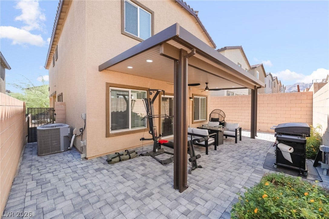10958 Cheshire Woods Avenue, Las Vegas, NV 89166 An inviting covered patio features modern paving stones and structured columns.