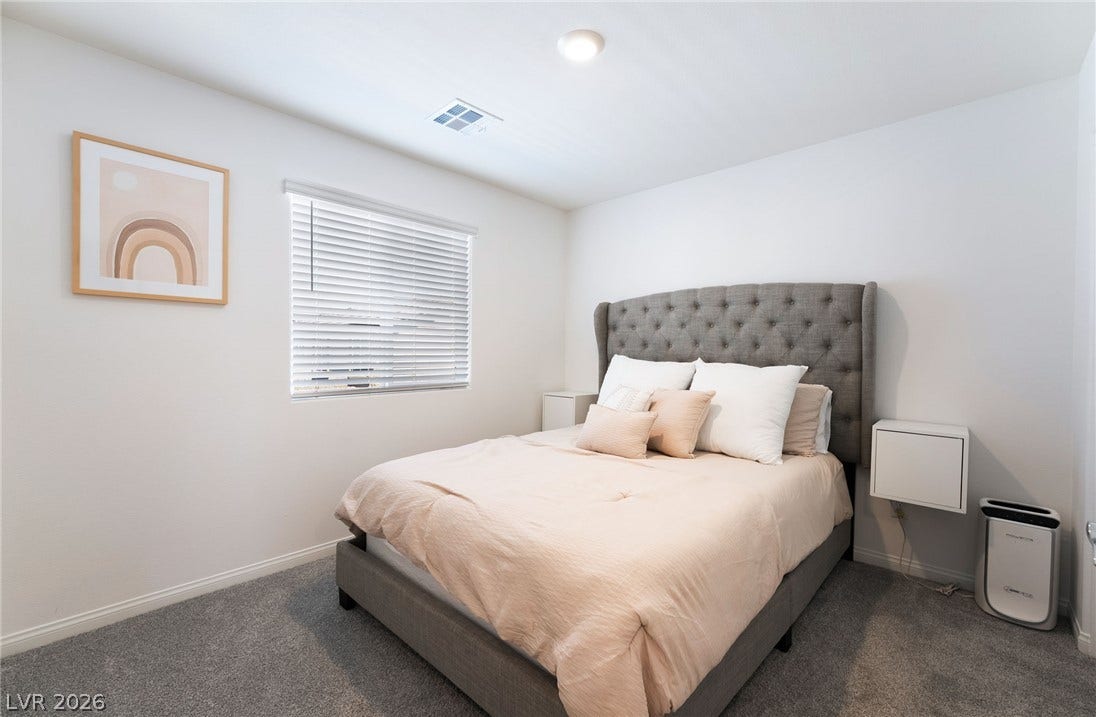 10958 Cheshire Woods Avenue, Las Vegas, NV 89166 Plush wall-to-wall carpeting and clean lines define this serene bedroom space.