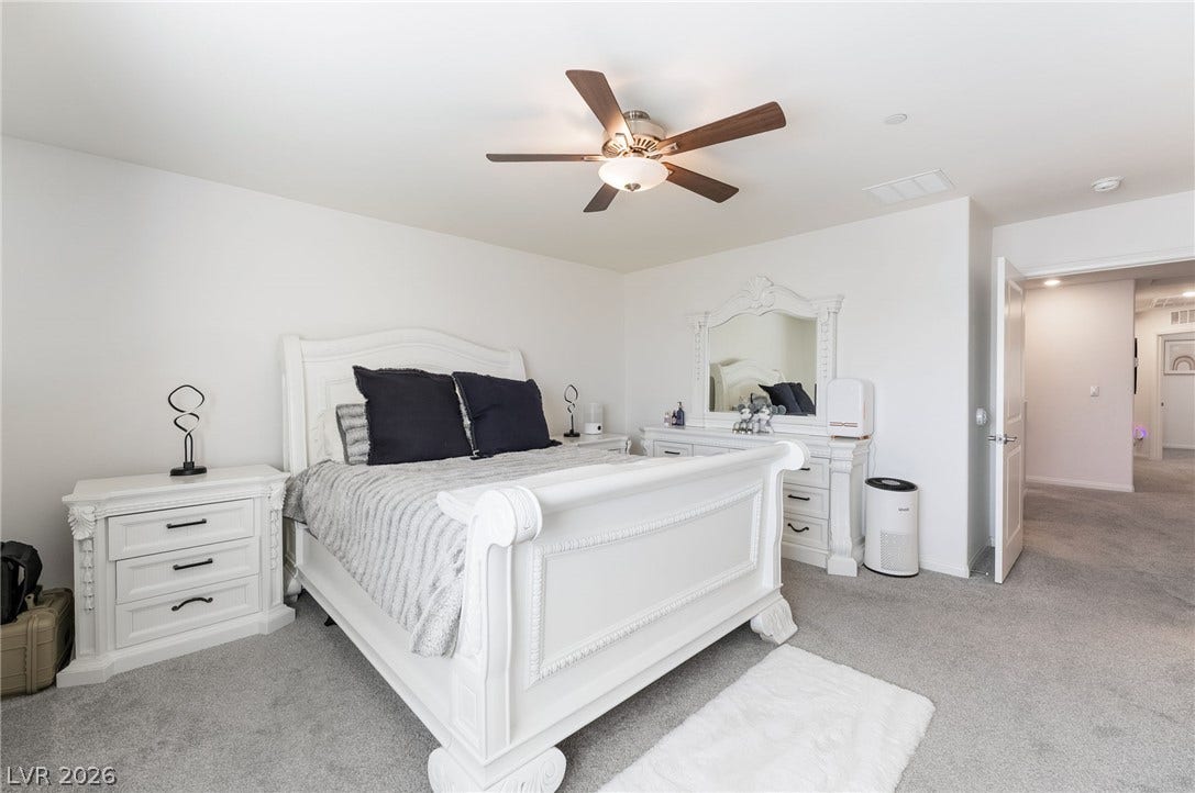 10958 Cheshire Woods Avenue, Las Vegas, NV 89166 Plush wall-to-wall carpeting and clean white walls define this comfortable bedroom space.