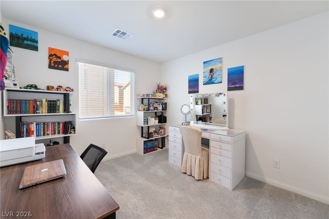 10958 Cheshire Woods Avenue, Las Vegas, NV 89166 Plush carpeting and natural light flowing through a wide window define this versatile space.