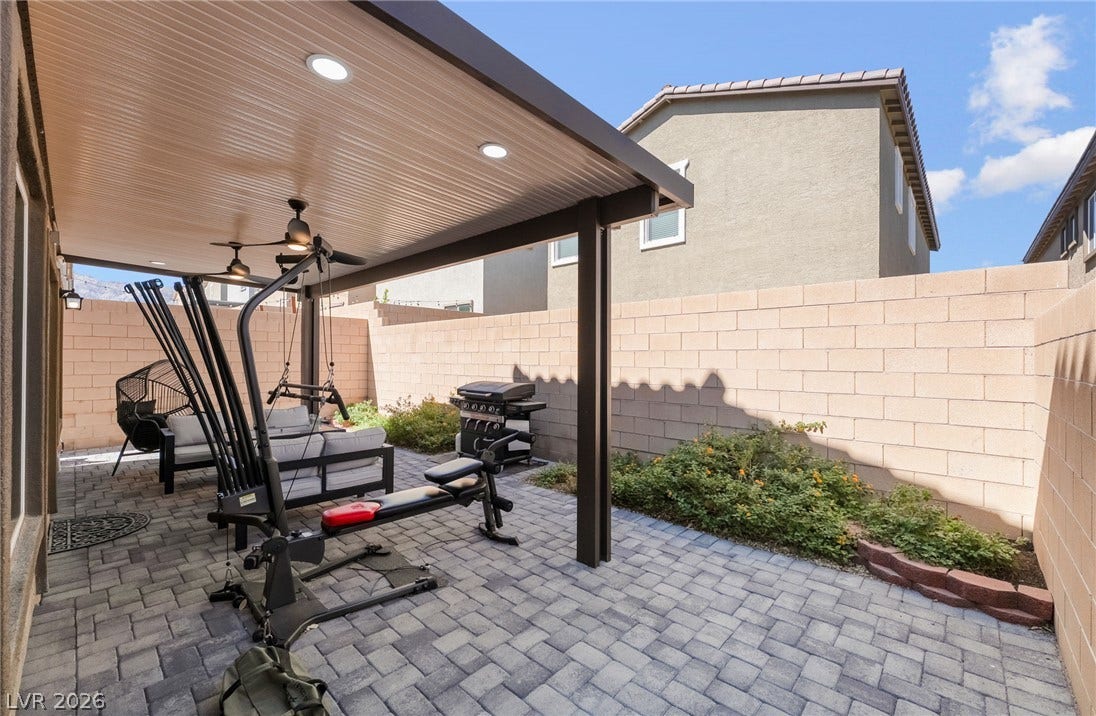 10958 Cheshire Woods Avenue, Las Vegas, NV 89166 An inviting covered patio features extensive stone pavers, recessed lighting, and a private block-wall perimeter.