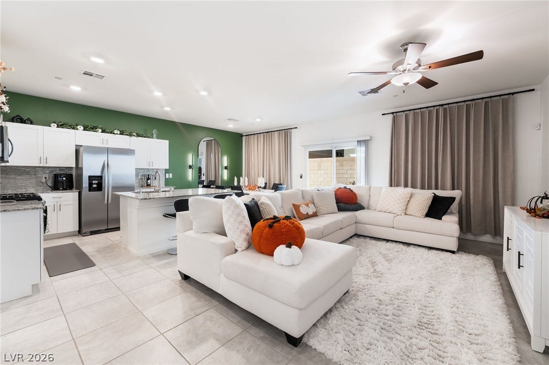 10958 Cheshire Woods Avenue, Las Vegas, NV 89166 An open floorplan seamlessly connects the modern kitchen and living spaces under recessed lighting.