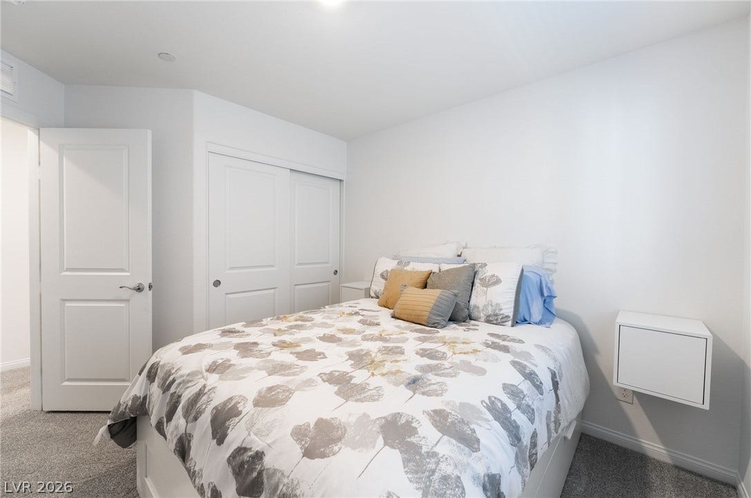 10958 Cheshire Woods Avenue, Las Vegas, NV 89166 A quiet bedroom offers soft carpeting and a spacious built-in sliding door closet.