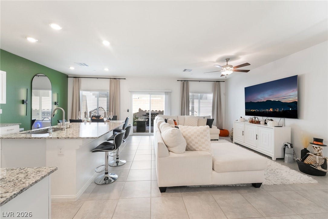 10958 Cheshire Woods Avenue, Las Vegas, NV 89166 An open floor plan seamlessly connects the kitchen bar to a spacious living area.