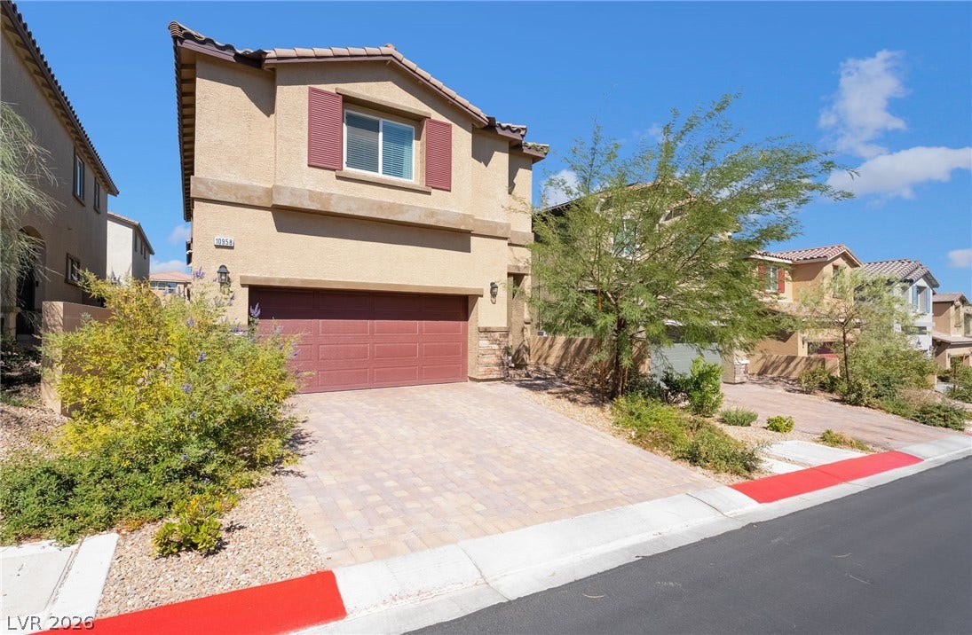 10958 Cheshire Woods Avenue, Las Vegas, NV 89166 Stucco exterior walls paired with a tile roof define this modern multi-level residence.