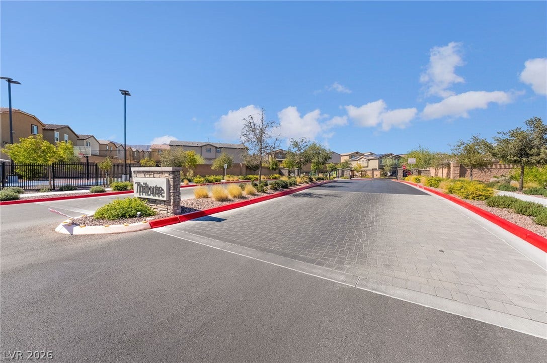 10958 Cheshire Woods Avenue, Las Vegas, NV 89166 An inviting gated entrance welcomes residents with clean paved roadways and manicured neighborhood landscaping.