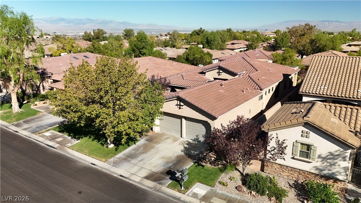 6 Mohansic Road, Henderson, NV 89052 Distant mountains frame this neighborhood setting featuring tile roofs and manicured lawns.