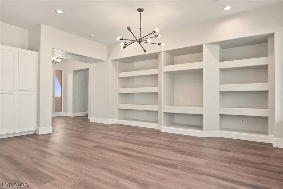 6 Mohansic Road, Henderson, NV 89052 Clean lines and custom built-in shelving define this versatile open space with wood-look flooring.