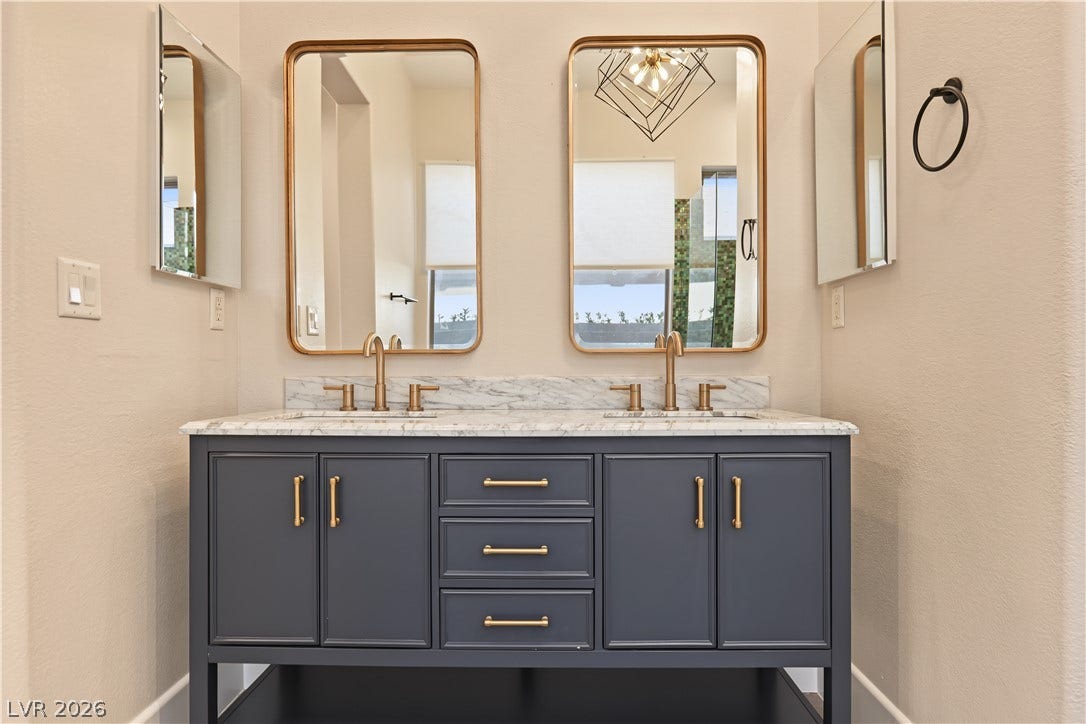 6 Mohansic Road, Henderson, NV 89052 A refined dual vanity with marble countertops serves as the centerpiece of this bathroom.