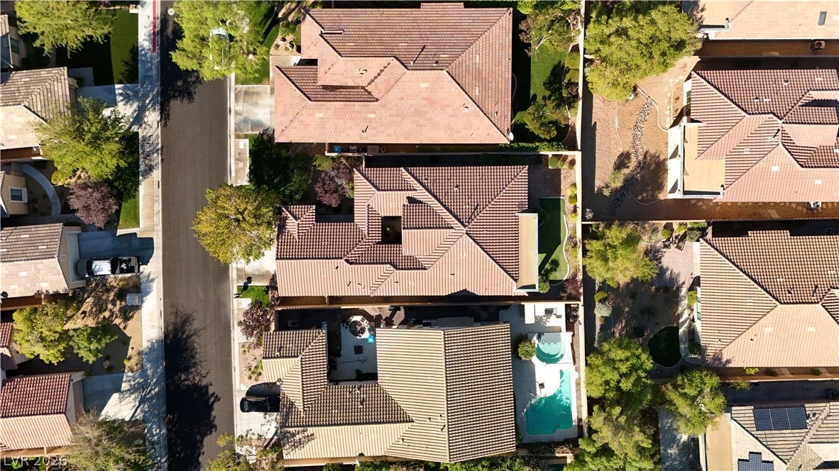 6 Mohansic Road, Henderson, NV 89052 An aerial perspective showcases the classic tile roofing and private pool of this suburban home.