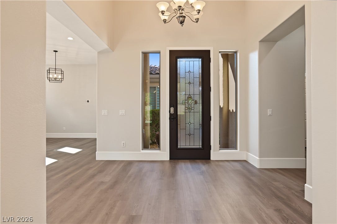 6 Mohansic Road, Henderson, NV 89052 High ceilings and clean wood-style flooring welcome guests inside this airy foyer.