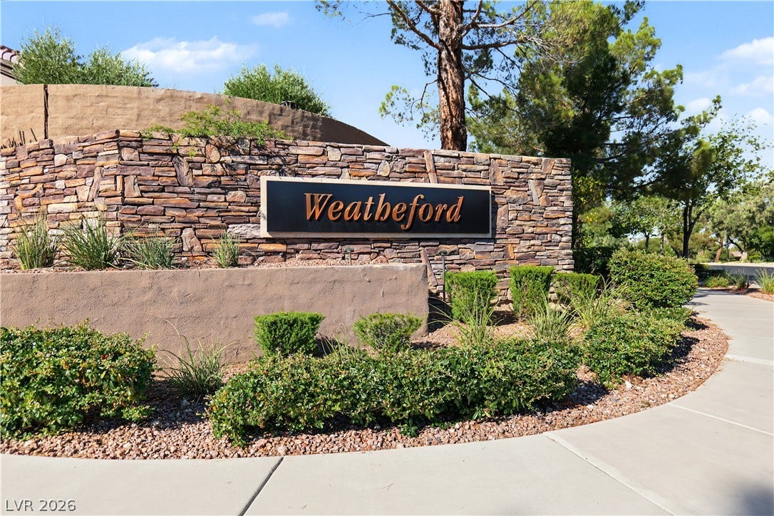 6 Mohansic Road, Henderson, NV 89052 A stone monument sign and paved walkway welcome visitors to this neighborhood entrance.