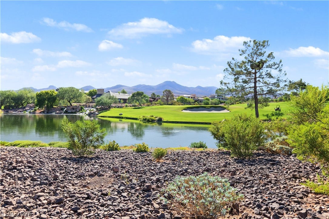6 Mohansic Road, Henderson, NV 89052 Gravel landscaping frames peaceful views of a scenic lake, golf green, and distant mountains.