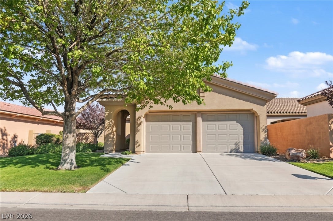 6 Mohansic Road, Henderson, NV 89052 A spacious driveway and private entry archway define this classic stucco exterior.