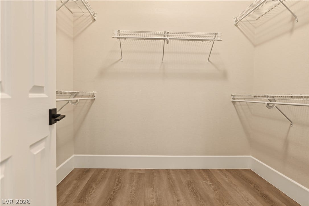 6 Mohansic Road, Henderson, NV 89052 Ample wire shelving lines this functional walk-in closet featuring durable wood-look flooring.