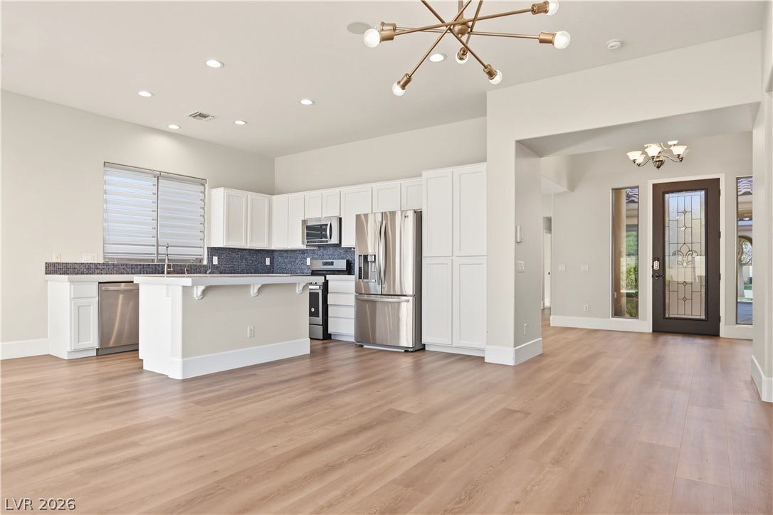 6 Mohansic Road, Henderson, NV 89052 Clean lines and warm wood floors define this open kitchen and adjoining entrance foyer.