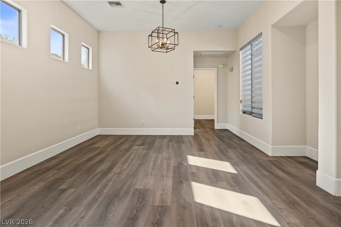 6 Mohansic Road, Henderson, NV 89052 Rich wood-inspired floors and clean architectural lines define this versatile dining area.