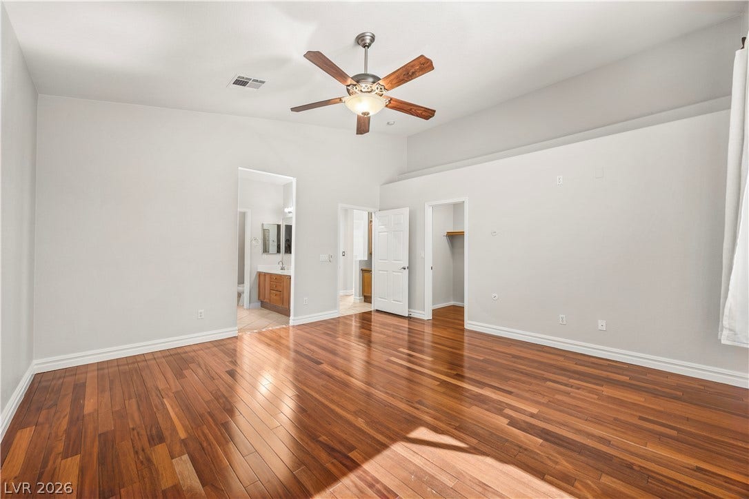 753 Wigan Pier Drive, Henderson, NV 89002 Rich hardwood floors and high ceilings define this versatile bedroom suite.