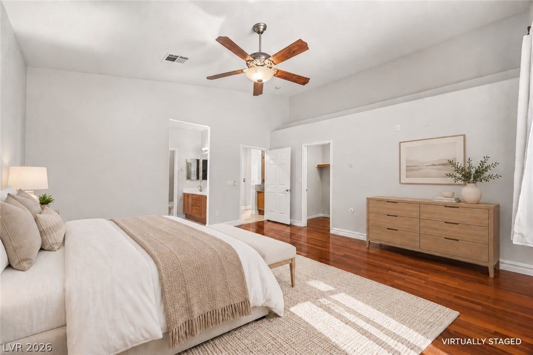 753 Wigan Pier Drive, Henderson, NV 89002 Rich hardwood flooring anchors this light-filled bedroom suite featuring high ceilings and multiple entryways.