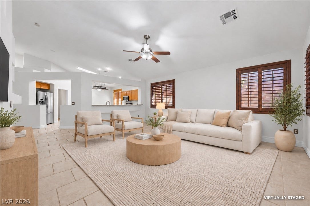 753 Wigan Pier Drive, Henderson, NV 89002 An open-concept living area features warm tile floors under soaring vaulted ceilings.