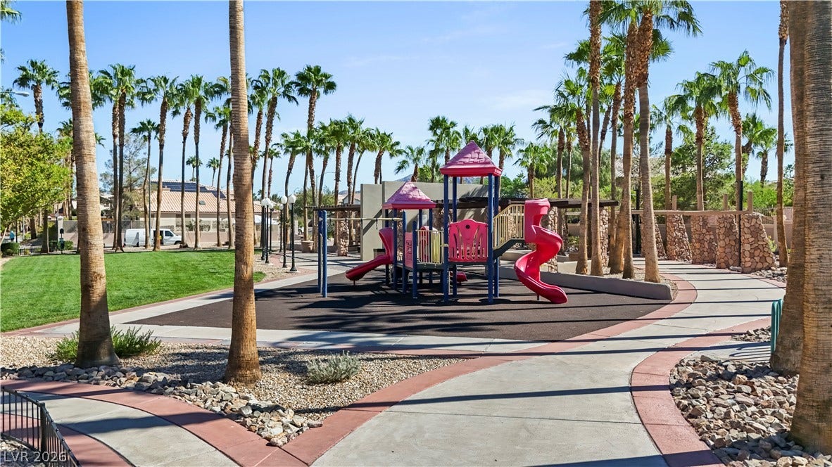 753 Wigan Pier Drive, Henderson, NV 89002 Towering palm trees surround a vibrant community playground bordered by paved walking paths.
