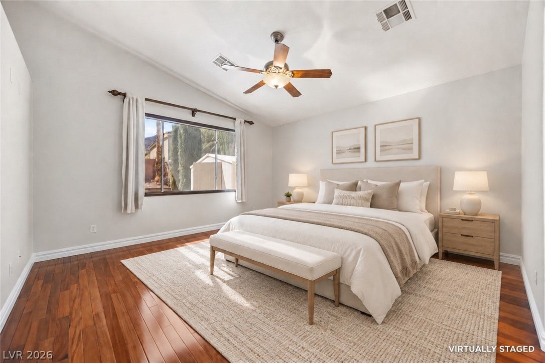 753 Wigan Pier Drive, Henderson, NV 89002 Gleaming hardwood floors and a vaulted ceiling frame this inviting bedroom retreat.