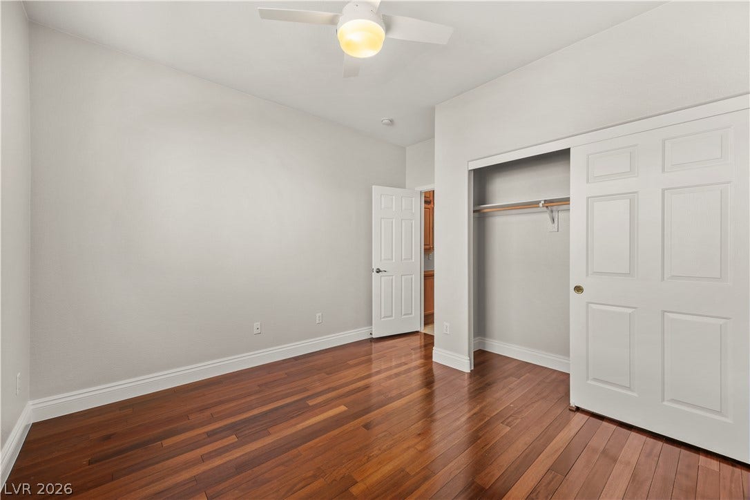 753 Wigan Pier Drive, Henderson, NV 89002 Rich hardwood floors and a built-in closet define this versatile secondary bedroom space.