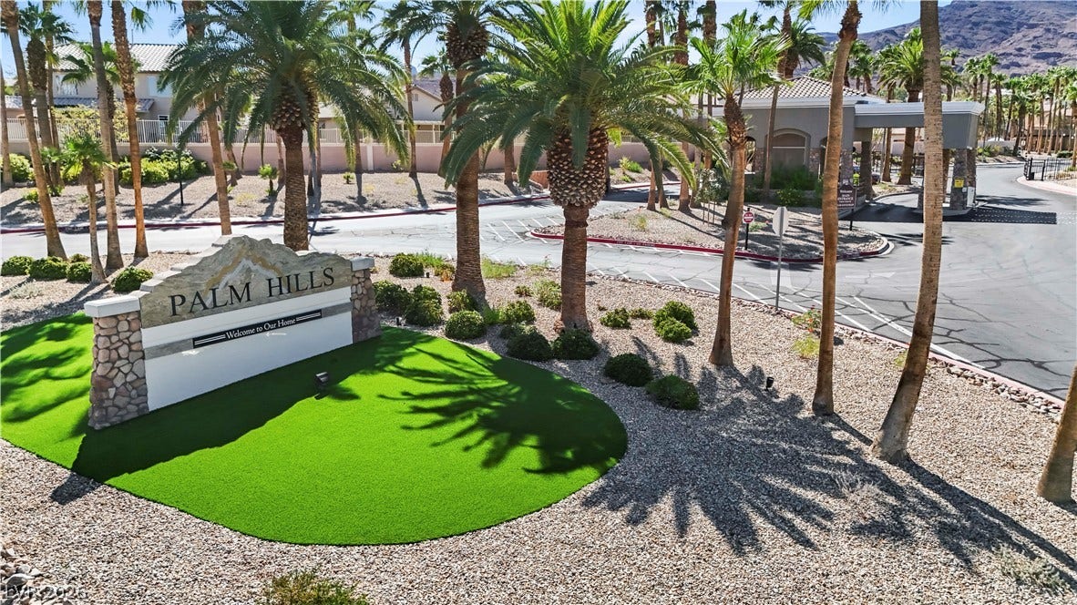 753 Wigan Pier Drive, Henderson, NV 89002 Manicured desert landscaping and mature palm trees welcome residents through the secure gated entry.