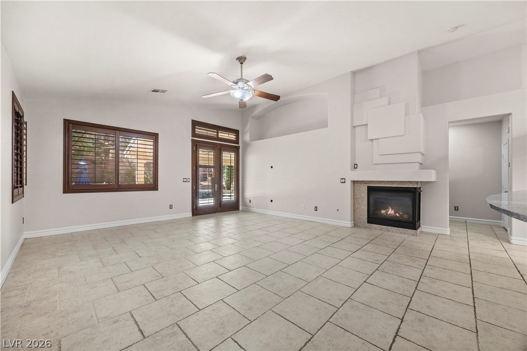 753 Wigan Pier Drive, Henderson, NV 89002 Tiled flooring and a modern fireplace anchor this open living area.