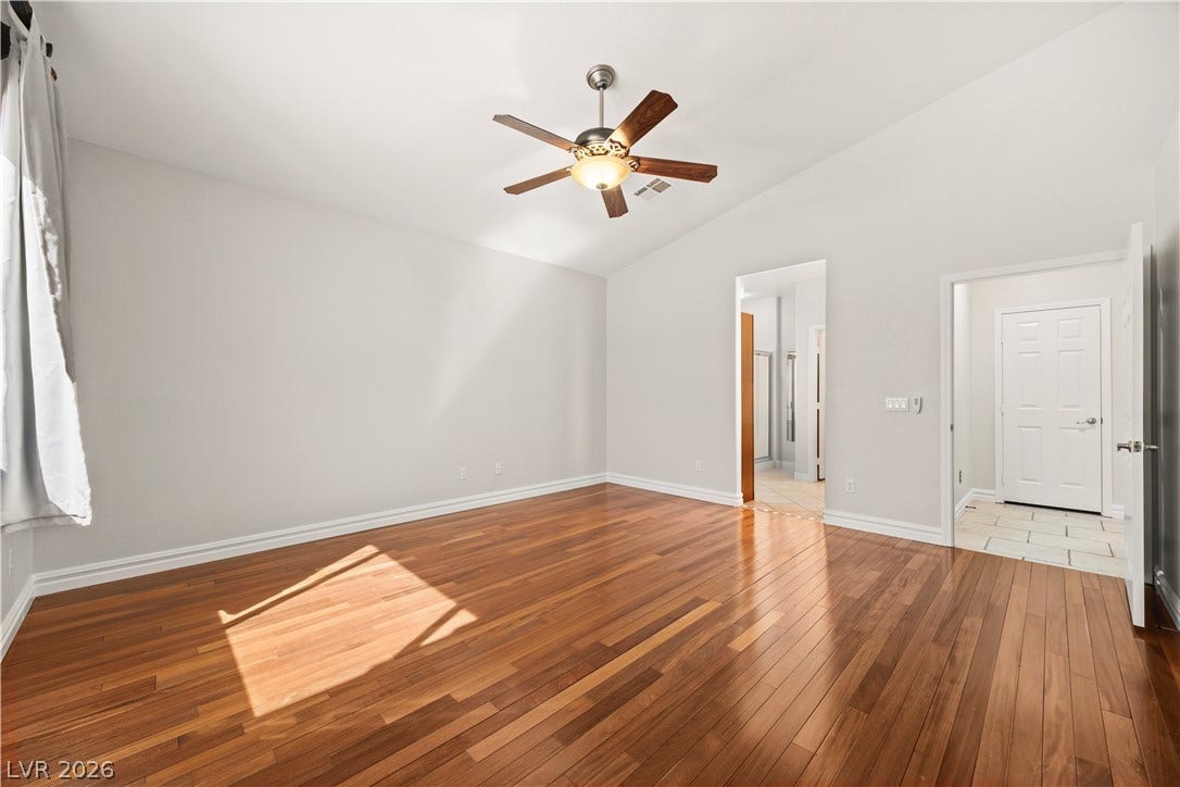 753 Wigan Pier Drive, Henderson, NV 89002 Rich hardwood floors and soaring vaulted ceilings define this peaceful, sunlit bedroom retreat.