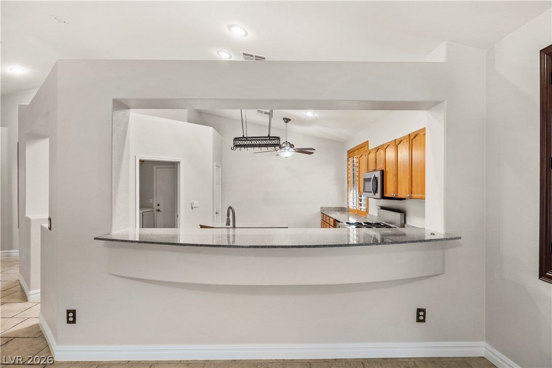 753 Wigan Pier Drive, Henderson, NV 89002 An open pass-through breakfast bar connects the living space directly to the kitchen.