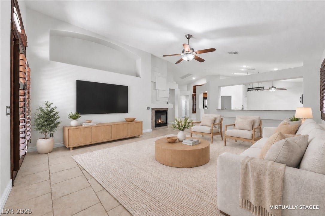 753 Wigan Pier Drive, Henderson, NV 89002 High ceilings and a fireplace anchor the open living area featuring classic tile flooring.