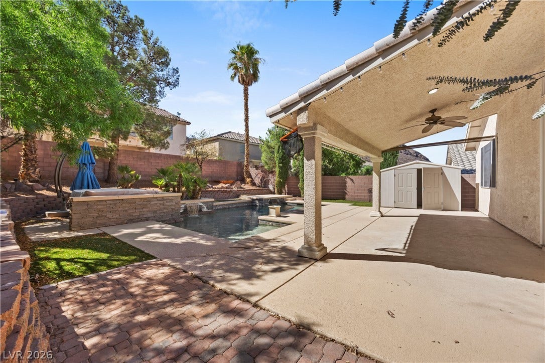 753 Wigan Pier Drive, Henderson, NV 89002 An inviting covered patio overlooks the private backyard swimming pool and separate spa area.