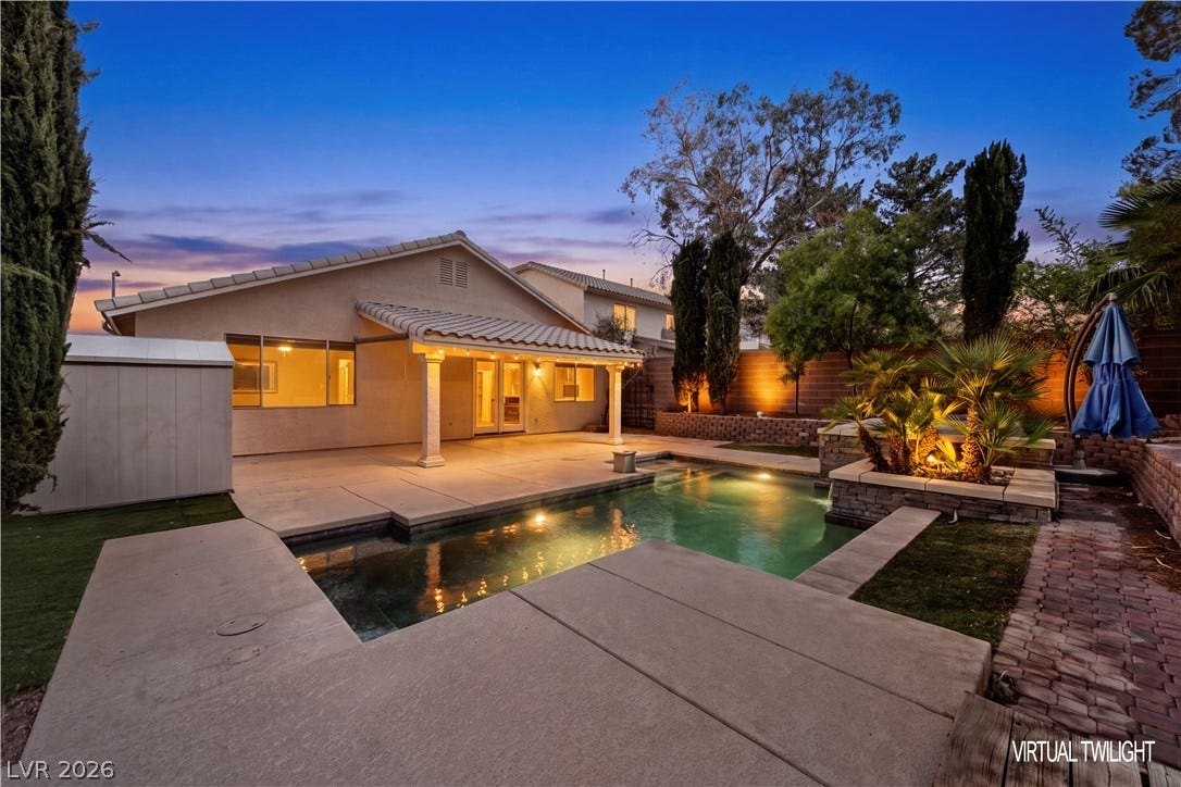 753 Wigan Pier Drive, Henderson, NV 89002 A sparkling in-ground pool anchors the backyard space complete with a covered patio area.