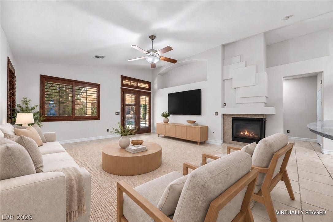 753 Wigan Pier Drive, Henderson, NV 89002 A warm fireplace anchors this spacious living area with tall ceilings and tile flooring.