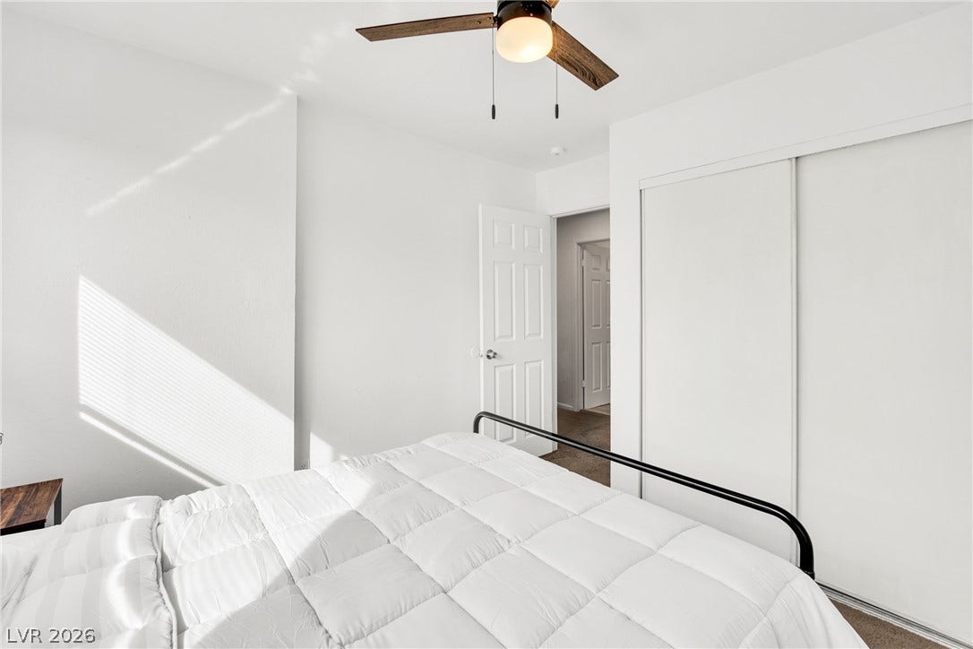 Natural light streams across clean walls and a spacious sliding-door closet.