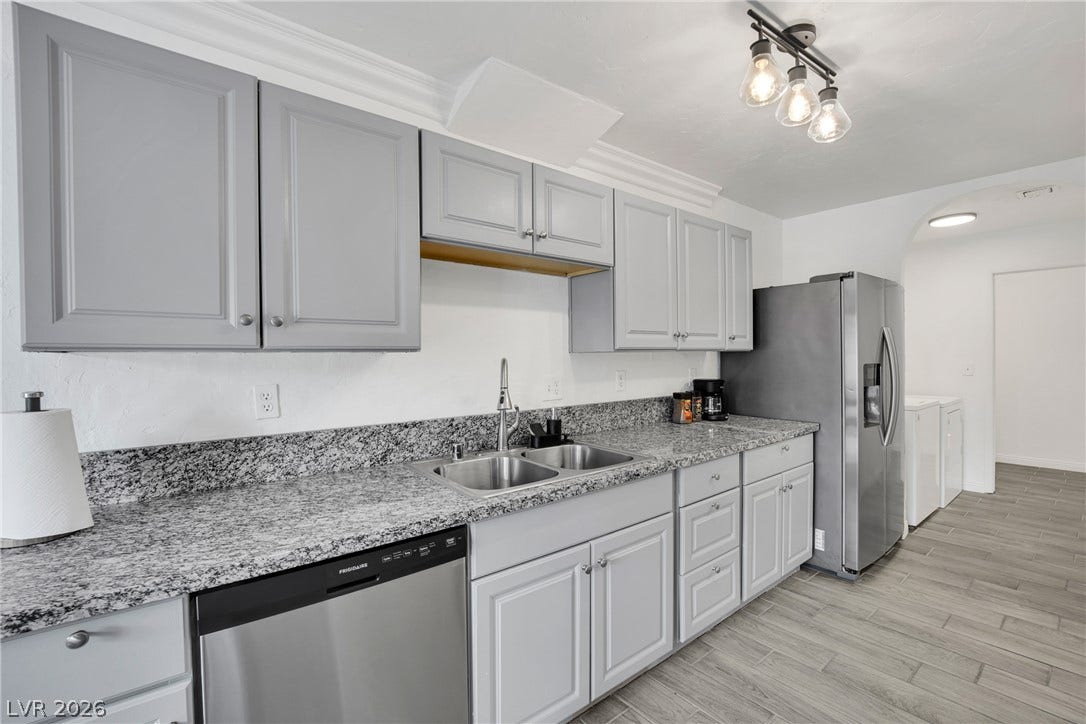 Classic crown molding and durable stone countertops elevate this highly functional culinary space.
